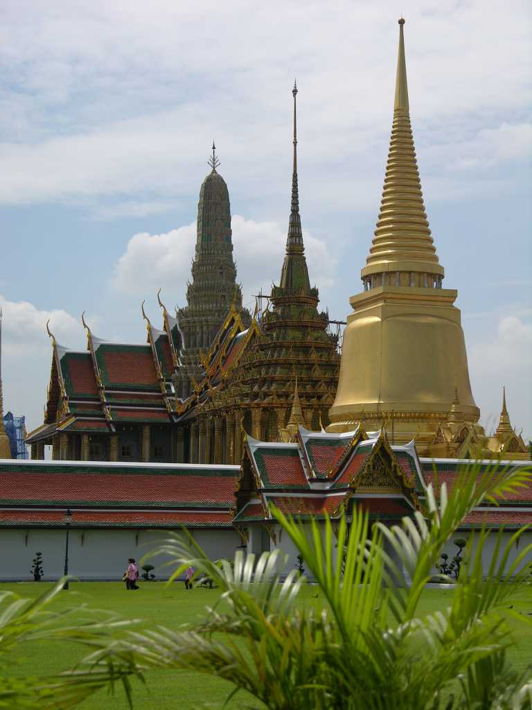 Bangkok 04 01 Wat Phra Kaeo Golden Phra Siratana Chedi, the Mondop, and the Royal Pantheon The Grand Palace was established in 1782, when King Rama I moved the capital from Thonburi to Bangkok. It is surrounded by four walls, 1900m in length. The Wat Phra Kaeo, or Temple Of The Emerald Buddha, was built inside The Grand Palace walls in 1785 by Rama I as a royal chapel. There are three monuments just as you enter Wat Phra Kaeo, a reliquary in the shape of a golden chedi, the Mondop, modeled on Ankor Wat a repository for Buddhist sacred scriptures inscribe on palm, and the Royal Pantheon in which statues of past kings of the Chakri dynasty are enshrined.